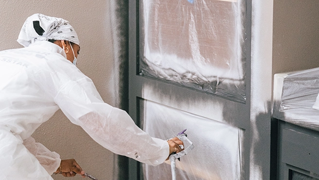 Five Star Painting professional refacing a cabinet.