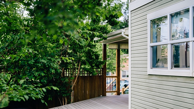 Wooded exterior of a home and view of a wooden deck.
