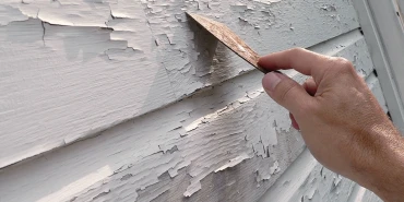 Person removing white paint.